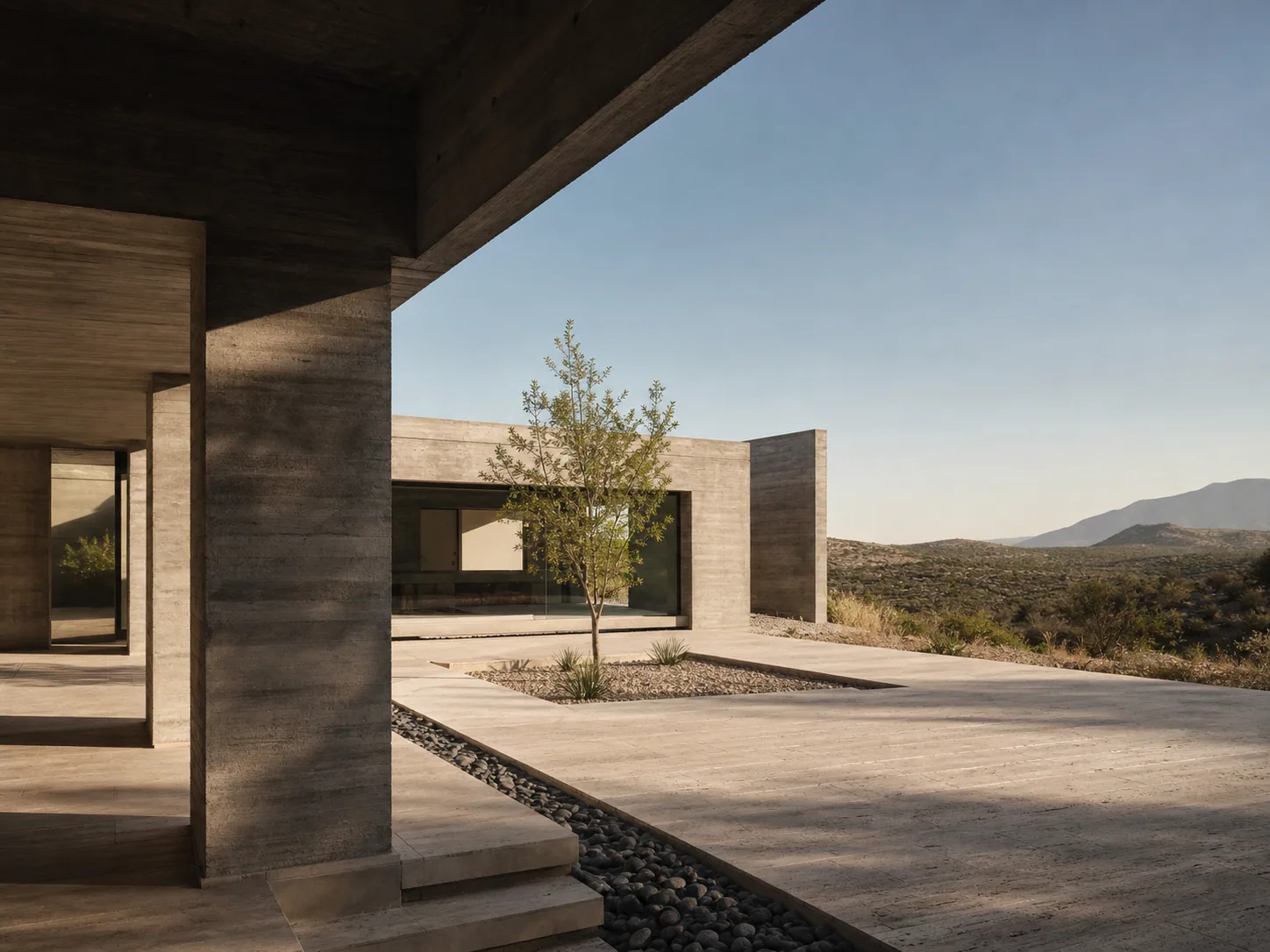 Casa contemporánea de concreto en un paisaje semidesértico.